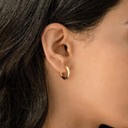 A close-up of a woman's ear with straight dark hair shows her wearing the Diamond Butterfly Earrings Set—ideal for layering or pairing with small gold hoops for a chic, delicate look.