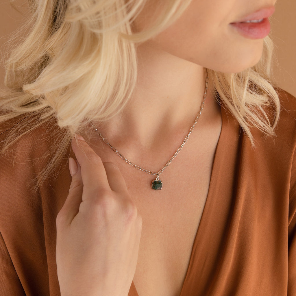 Woman with blonde hair wears a brown top and the Agate Pendant Necklace, a silver handmade gemstone piece featuring a green agate pendant.