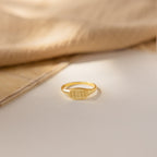 Old English Signet Ring engraved with Roman numerals 11:11, displayed on a light surface with soft fabric in the background—ideal for fans of personalized minimalist jewelry.