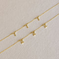 The Alice Spaced Number Necklace set features three delicate gold chains with small gold number pendants—one necklace with a "1" and two with a "2"—perfect for anyone who loves a minimalist, elegant look.
