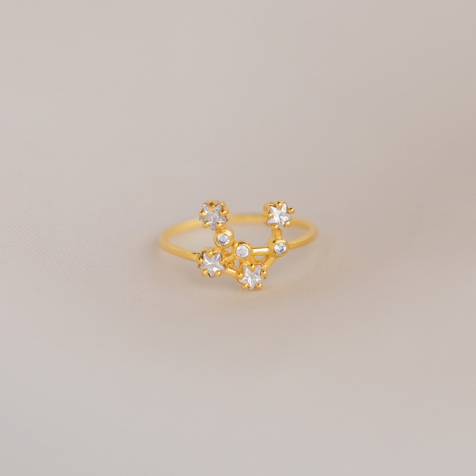 The Constellation Ring features a gold band adorned with sparkling diamonds, embodying the elegance of celestial-inspired jewelry.