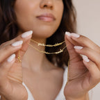 Woman wearing the Petite Tiny Multiple Name Bracelet personalized with names—ideal for minimal jewelry lovers or anyone seeking a custom touch to their style.