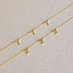 Three Old English Spaced Number Necklaces with gold chains and small gold number “1” and “2” pendants displayed on a textured surface, highlighting a personalized vintage charm jewelry style.