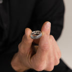 A person in black holds the Thick Half Round Fingerprint Ring, featuring partial "Hero Wit" engraving and highlighting the elegance of personalized jewelry.