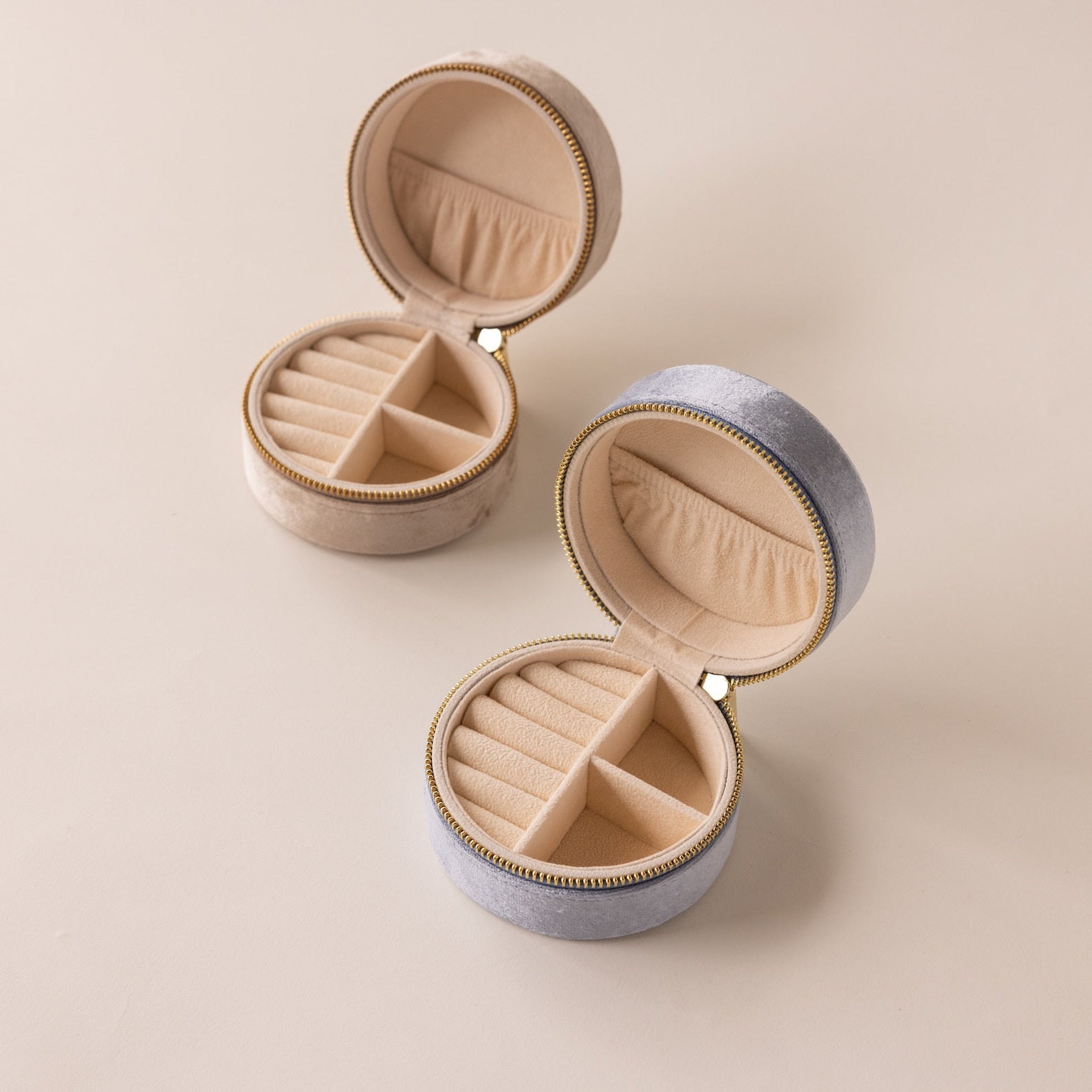 The Round Velvet Jewelry Case comes in beige or gray, each opening to display ring and compartment sections—perfect as a chic, minimalist travel jewelry organizer.