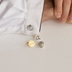 A hand in a white shirt displays three Engraved Cufflinks, one with "I ♥ PaPa" and others with custom designs.