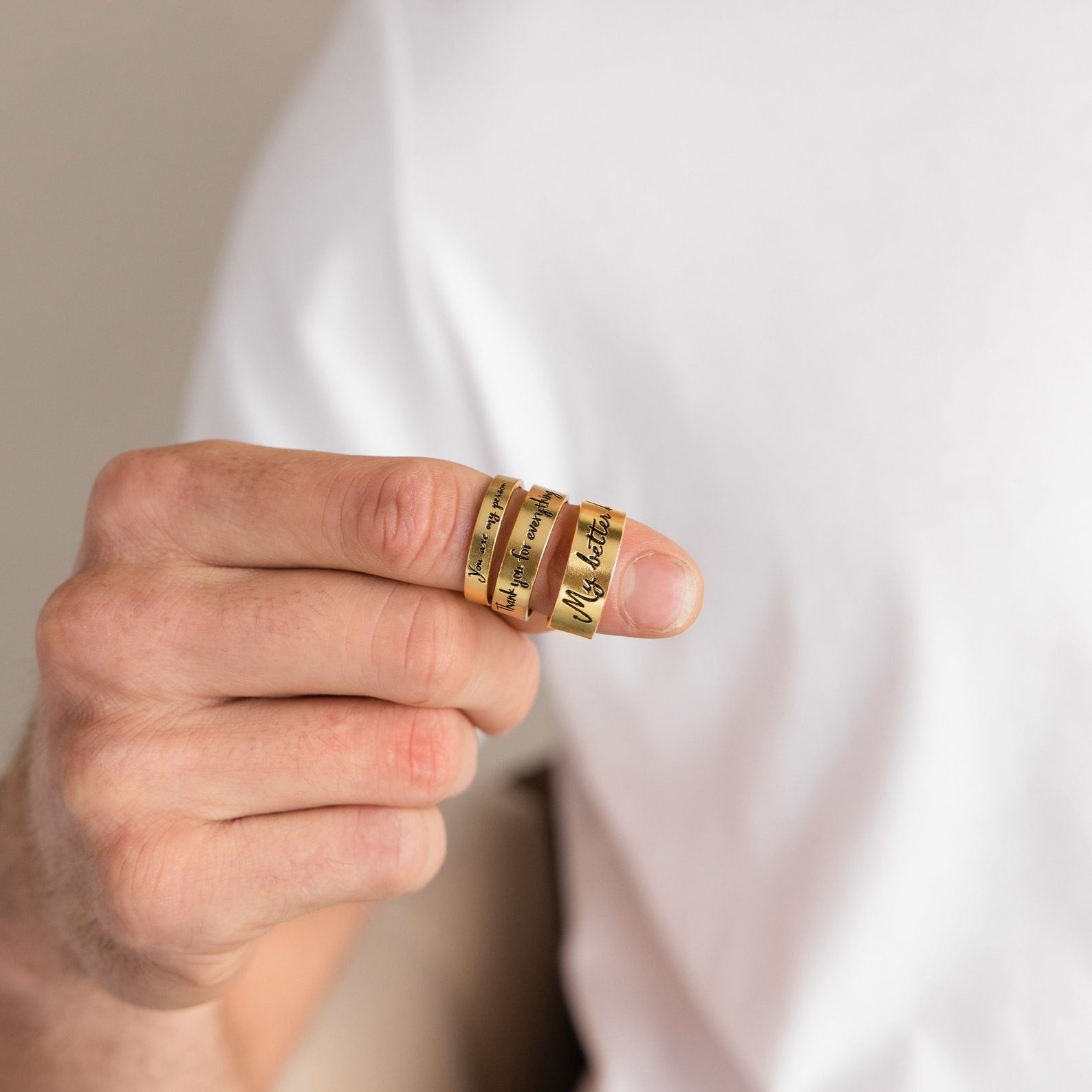 A person wearing the Handwriting Band with engraved text on their index finger, hand near chest—a meaningful Christmas gift or a unique custom ring.