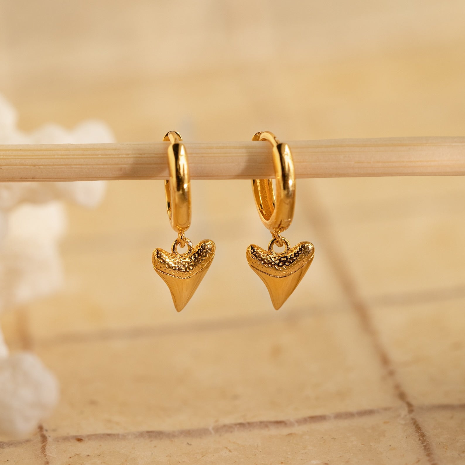 Shark Tooth Huggies feature small, textured shark tooth-shaped pendants—unique Shark Tooth Earrings and a stylish addition to your beach jewelry collection.