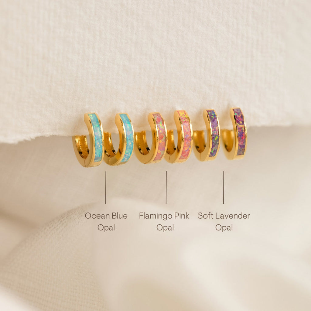 Add charm to your collection with the Pastel Opal Inlay Huggies—three pairs of gold hoop earrings featuring pastel opal inlays in blue, pink, and purple. Each pair is labeled by color, perfect for pastel opal jewelry lovers.