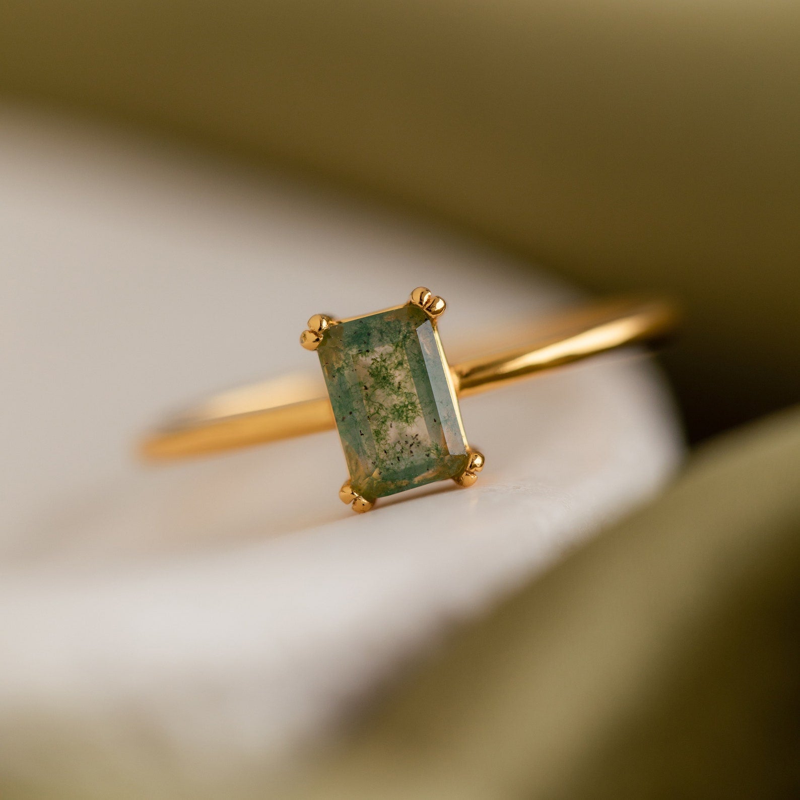 A macro close-up of the Agate Emerald Ring, focusing on the intricate textures and colors within the rectangular gemstone.