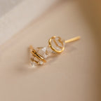 The Herkimer Diamond Studs are minimalist gold stud earrings with a clear stone, adding effortless elegance to any look.