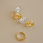 Five 3D Name Band rings in sterling silver and gold with custom engraved names on a neutral background.