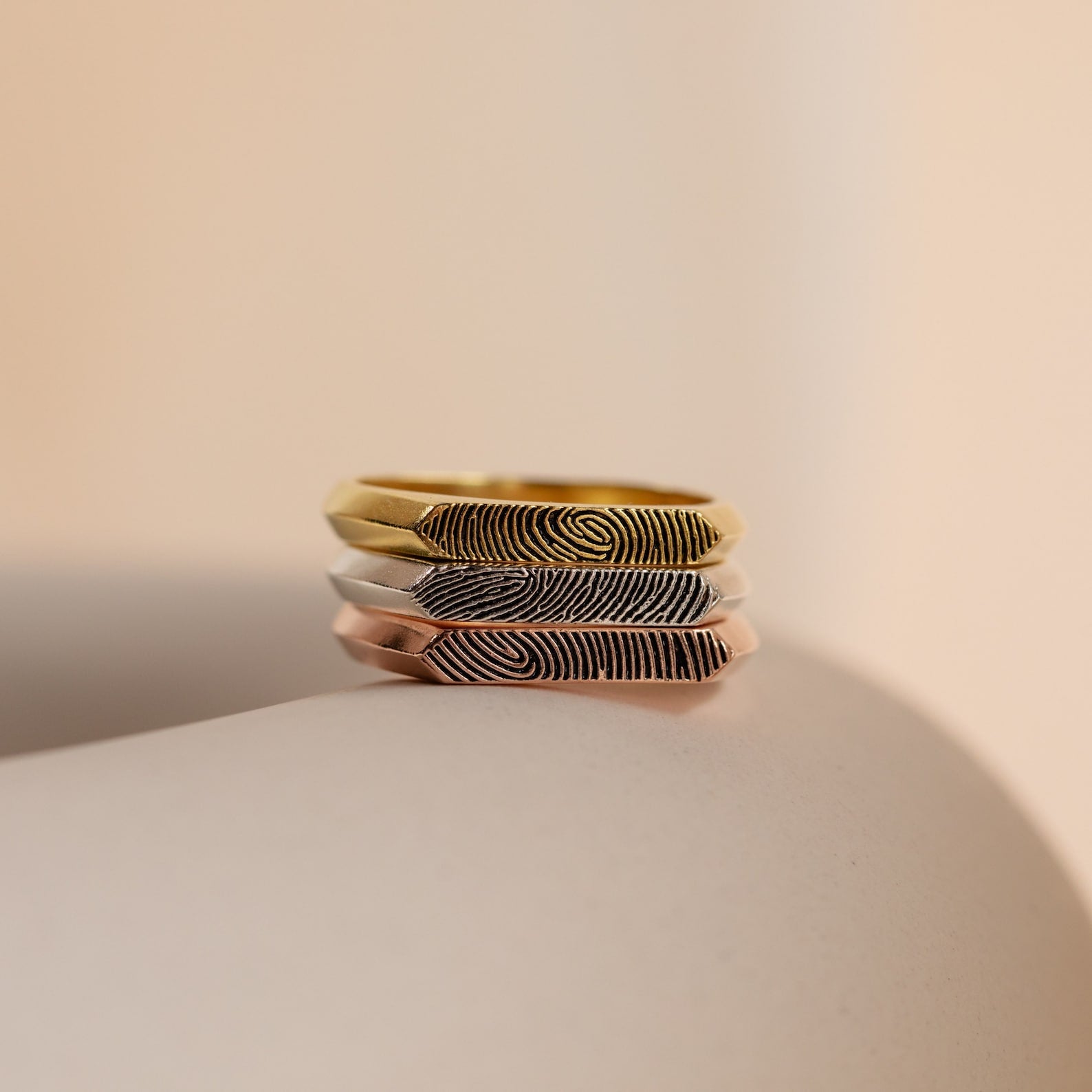 The Thin Fingerprint Signet Ring features a unique fingerprint pattern engraved on gold, silver, or rose gold—an ideal personalized gift or promise ring to treasure forever.
