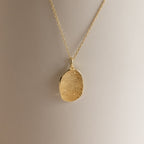 Custom Fingerprint Necklace in Rose Gold featuring an oval pendant engraved with a unique fingerprint, shown on a neutral background—an ideal sentimental gift.