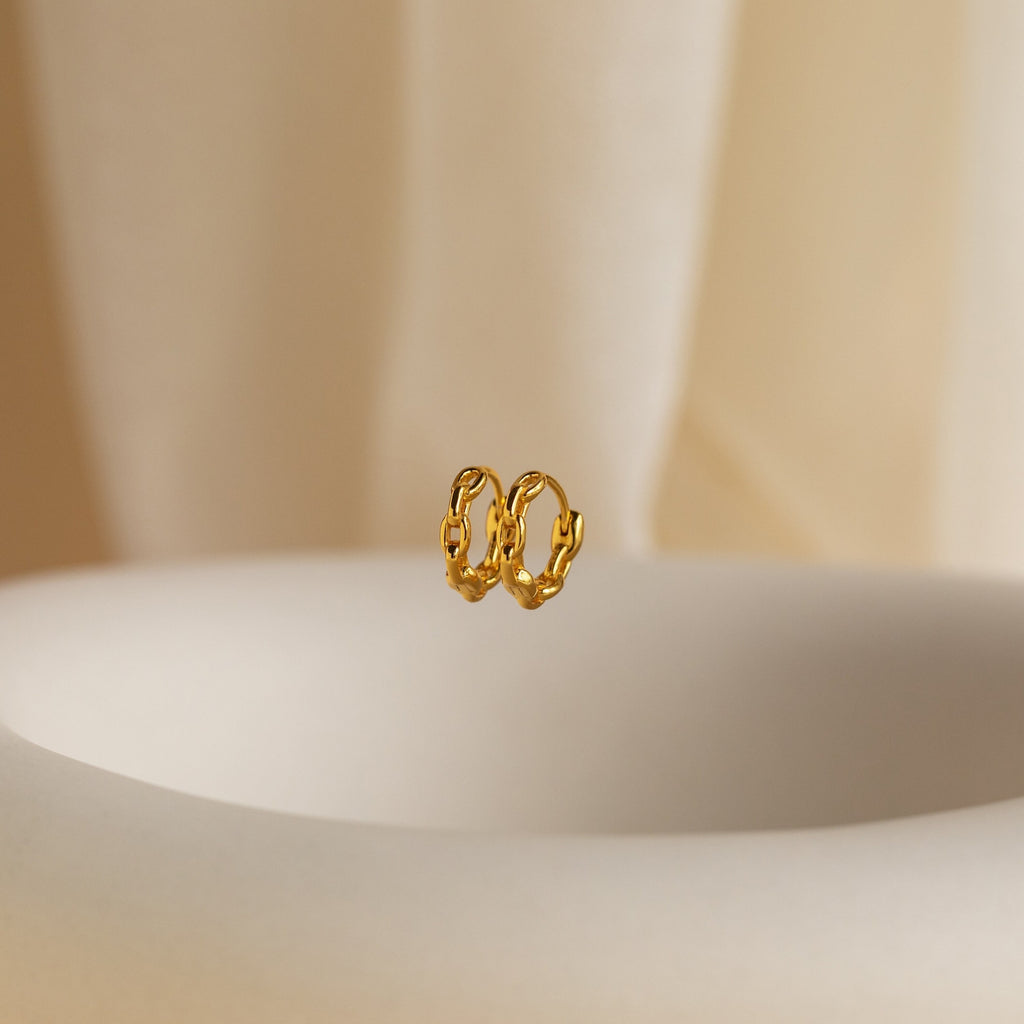 The Link Huggies float elegantly in the air, making them the perfect addition to your stylish earring stack.