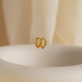 The Link Huggies float elegantly in the air, making them the perfect addition to your stylish earring stack.