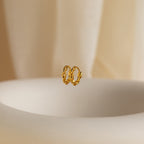 The Link Huggies float elegantly in the air, making them the perfect addition to your stylish earring stack.