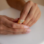 Close-up of hands holding a stacked Thin Fingerprint Signet Ring on a white surface—a unique personalized gift for any occasion.