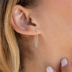 Close-up of a woman's ear wearing Baguette Chain Studs, her hand gently touching her neck and highlighting a chic, minimalist earring stack.