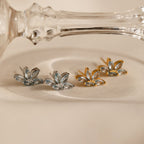 Two pairs of Aquamarine Marquise Studs, one in silver and one in gold, make a perfect bridesmaids gift, beautifully displayed on a light fabric surface.