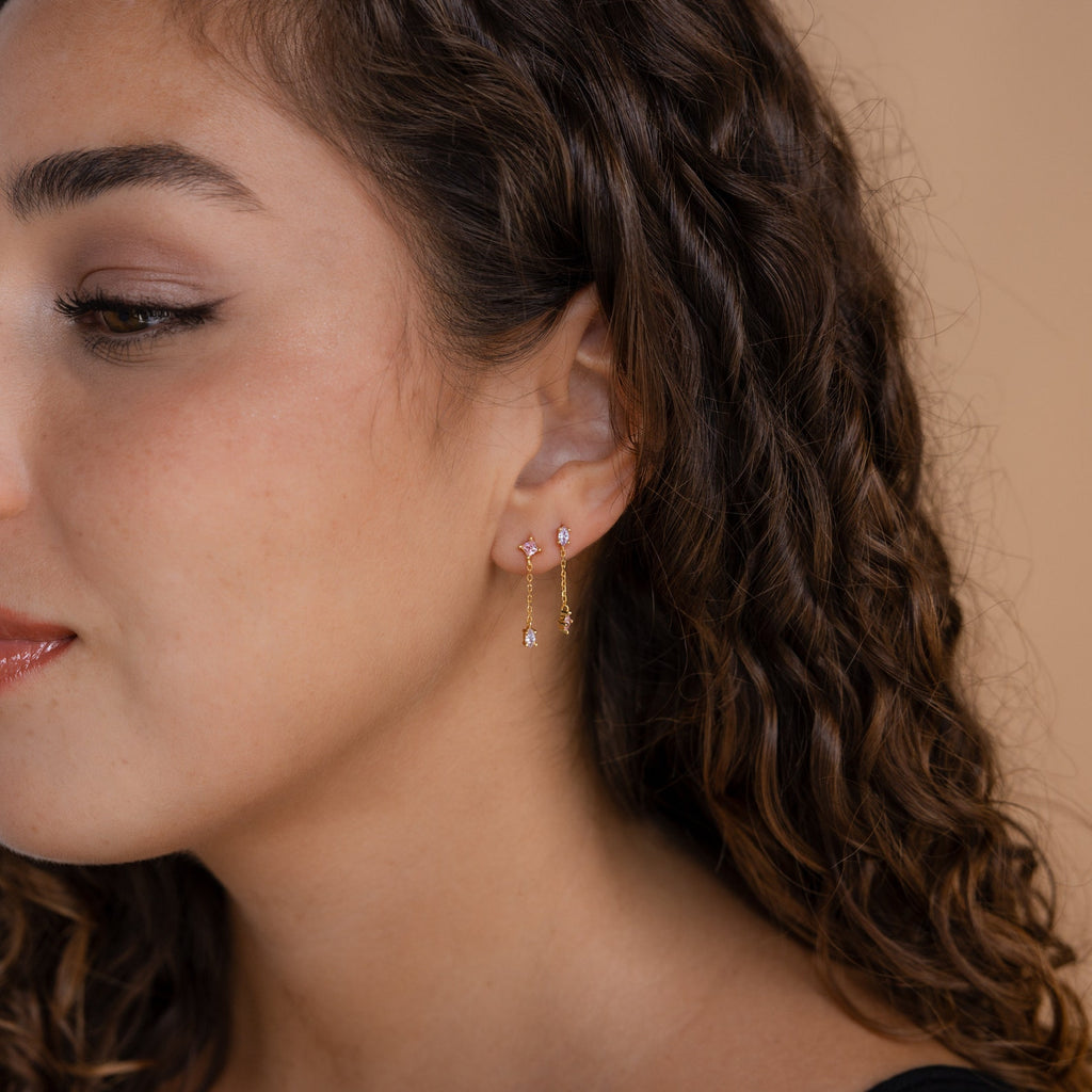 Woman with curly hair and natural makeup wears the Mixed Crystal Drop Earrings in a close-up profile view.