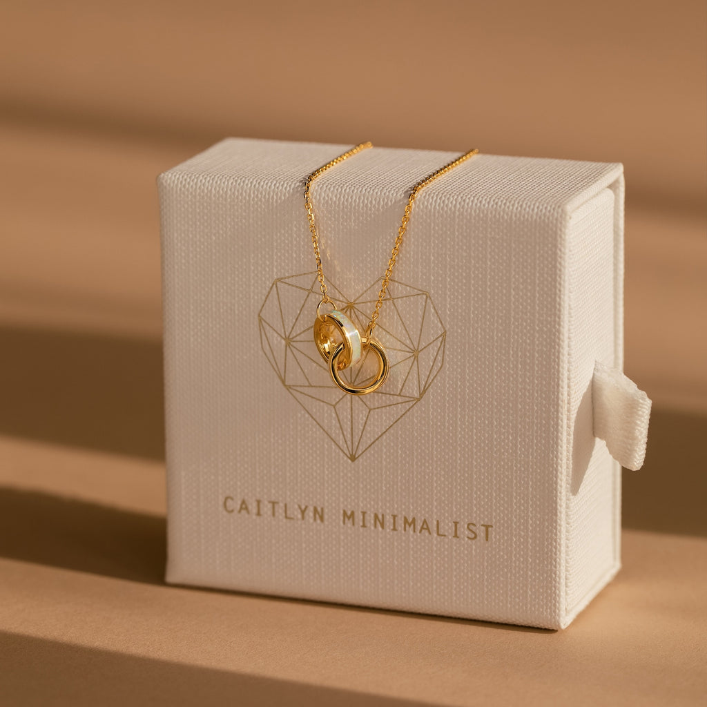 Interlocking Opal Inlay Bracelet showcased on a white jewelry box labeled “Caitlyn Minimalist”—ideal for minimalist jewelry lovers or pairing with a delicate necklace for an elegant touch.