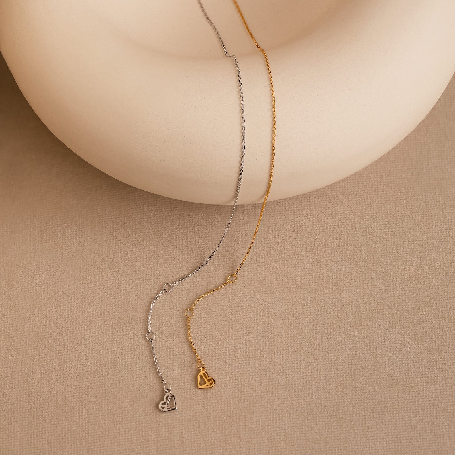 The Micro Rolo Chain Anklet features a delicate design in silver or gold with a tiny heart charm—ideal for fans of minimalistic jewelry.