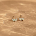 Add a playful touch to your style with the Opal Marquise Studs—elegant earrings featuring sparkling white opal stones in a chic design.
