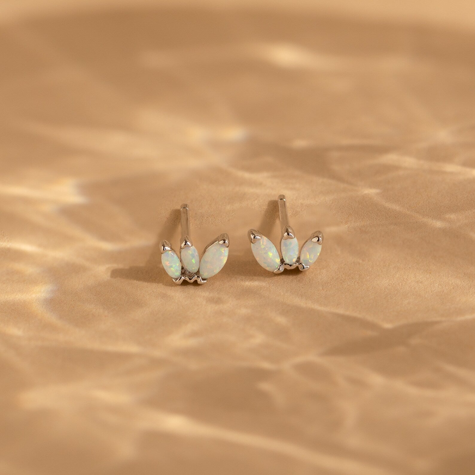 Add a playful touch to your style with the Opal Marquise Studs—elegant earrings featuring sparkling white opal stones in a chic design.