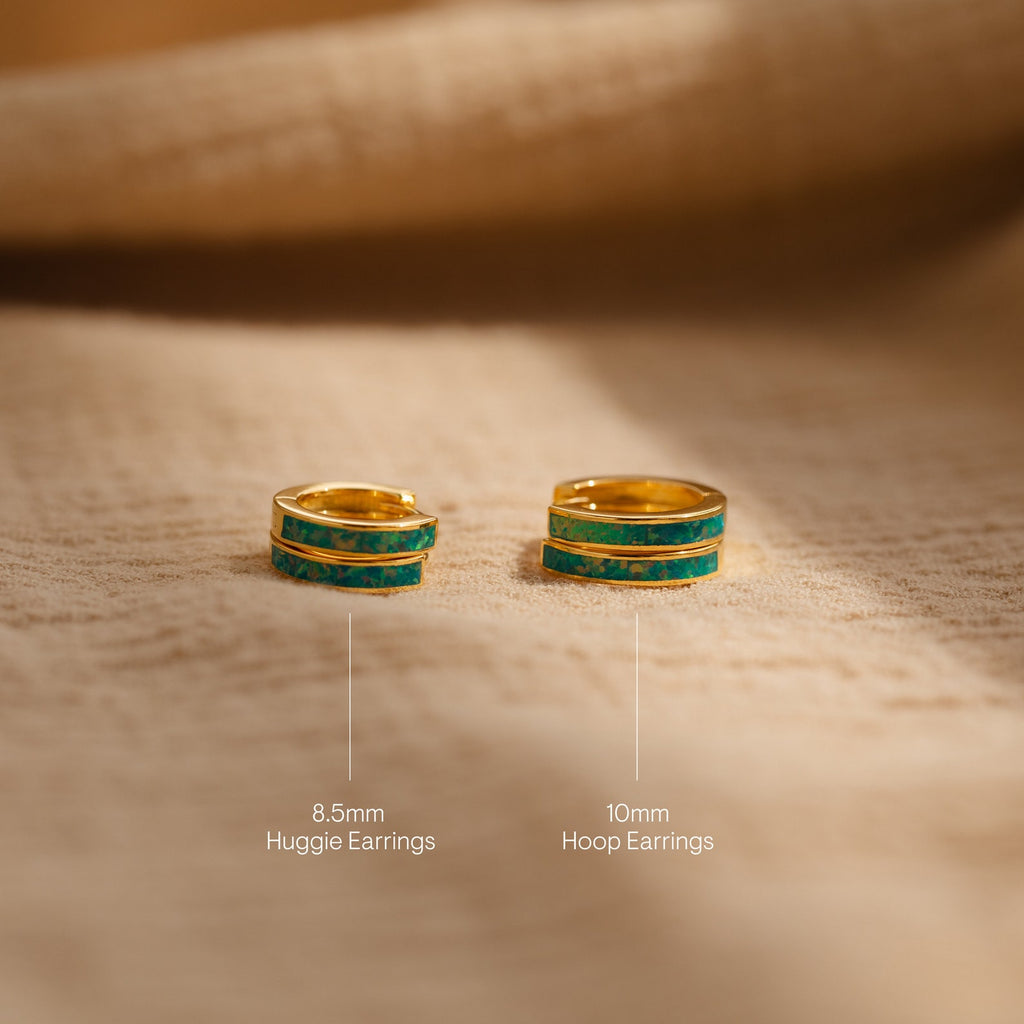 Two gold and turquoise dainty hoop earrings, called Green Opal Inlay Huggies in 8.5mm and 10mm sizes, are displayed on a beige surface.