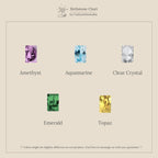 Five removable gemstones—Amethyst, Aquamarine, Clear Crystal, Emerald, and Topaz—on a beige background; perfect for personalizing your Dangling Emerald Birthstone Hoops.