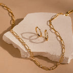 Diamond Link Hoops displayed on a light stone against a beige background.