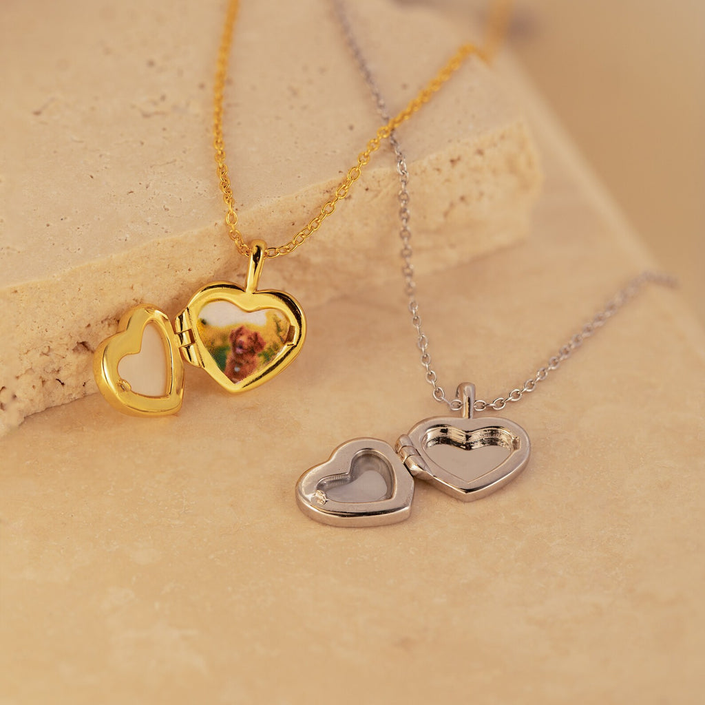 The Pearl Heart Locket Necklace features a heart-shaped locket that opens to hold a small photo—timeless, nostalgic jewelry perfect as a meaningful charm.
