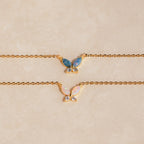 The Pink Opal Butterfly Necklace features a gold chain and a delicate butterfly pendant, adding a whimsical touch to any look. Perfect for layering with your favorite gemstone charm necklaces.