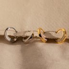 The Crescent Moon Opal Huggies are gold and silver hoop earrings perfect for stacking or wearing solo.