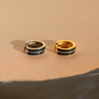 The Opal Inlay Hoops Set features one silver and one gold hoop earring, each with dark blue and red marbled opal inlay—perfect for adding a unique touch to wedding or bridal jewelry.