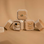 Four Velvet Ring Boxes, including one with 3 slots, showcase gold gemstone rings on a beige background—a perfect Velvet Ring Box set for presenting and gifting your favorite jewelry pieces.
