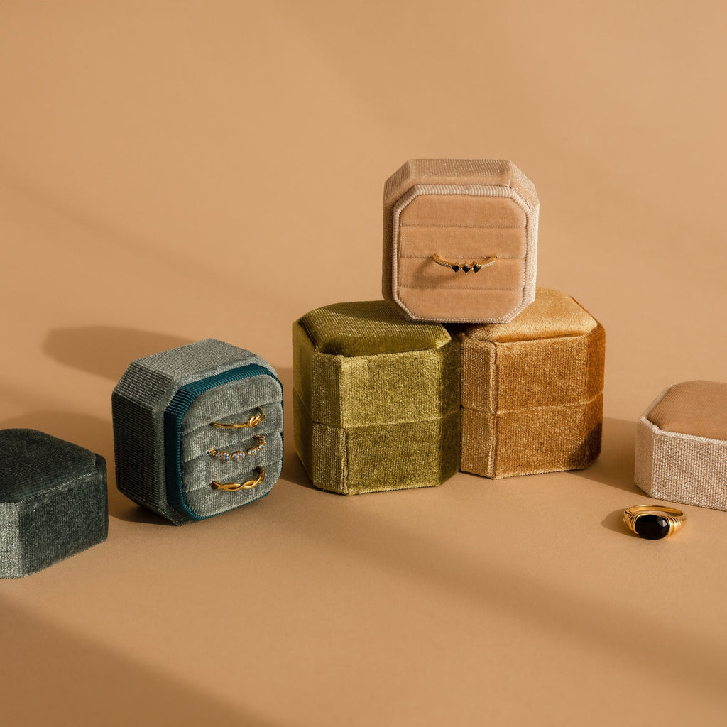 Velvet Ring Box in neutral tones shown stacked, with a 3-slot ring box displaying rings inside and another Velvet Ring Box presenting a ring on top.