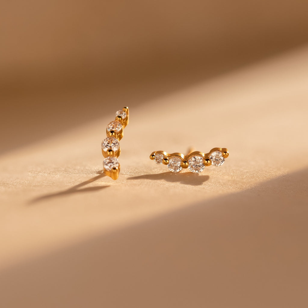 Tiny Diamond Climbers featuring three sparkling diamonds in each earring, displayed on a softly lit neutral surface—an ideal anniversary gift.