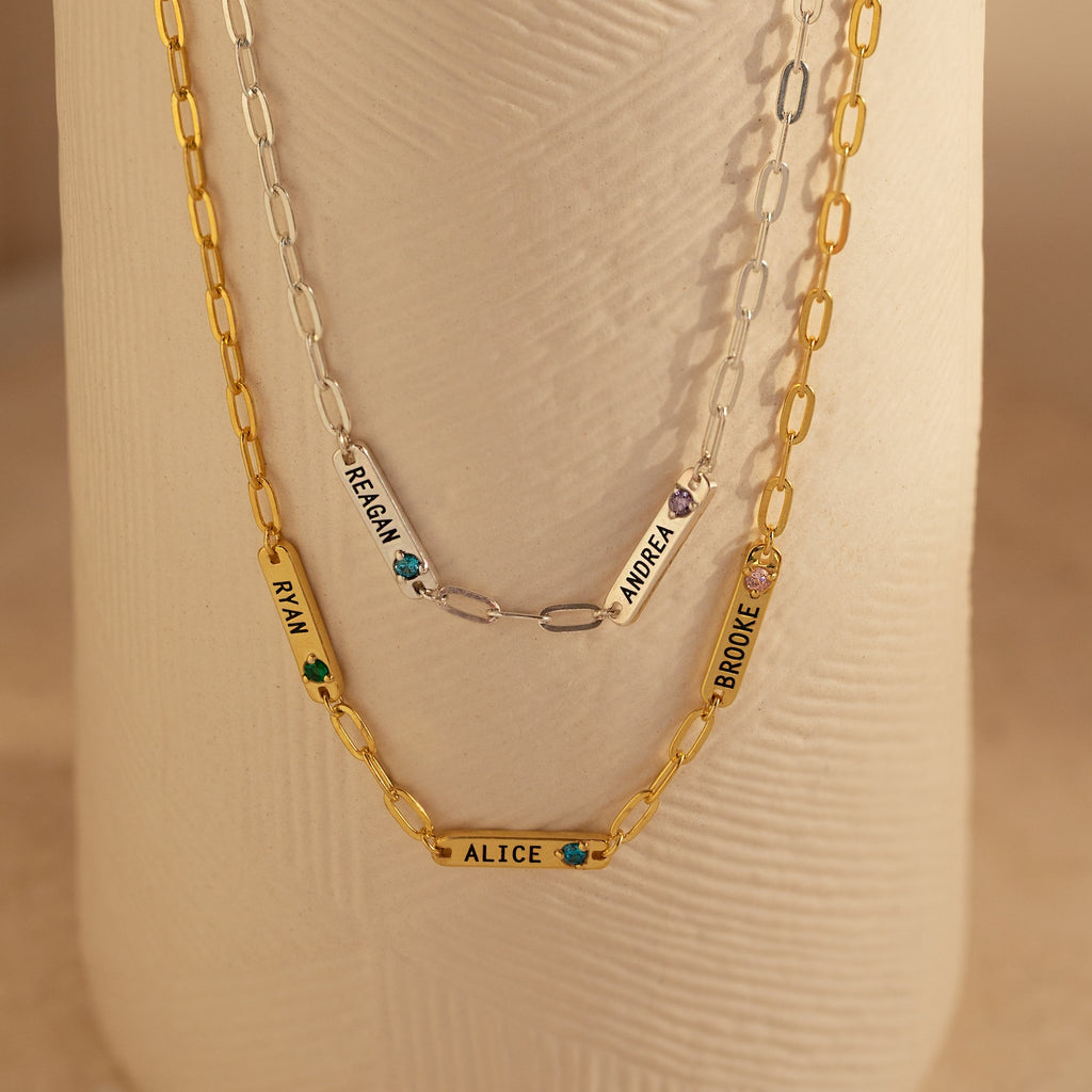 Two gold and one silver Mini Name Birthstone Necklaces featuring charms with names—RYAN, ALICE, REAGAN, ANDREA, BROOKE—are a perfect custom gift. Each paperclip chain adds a modern touch to this personalized accessory set.