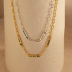 Two gold and one silver Mini Name Birthstone Necklaces featuring charms with names—RYAN, ALICE, REAGAN, ANDREA, BROOKE—are a perfect custom gift. Each paperclip chain adds a modern touch to this personalized accessory set.