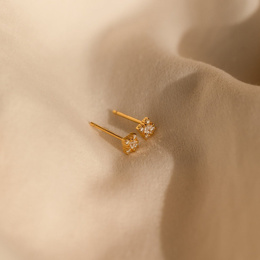 The Daydreamer Diamond Studs are glamorous gold earrings set with sparkling diamonds, perfect for adding a touch of elegance to any look.