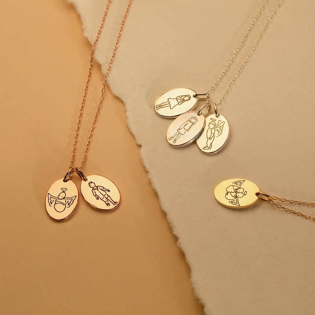The Child Portrait Necklace features four gold and rose gold engraved oval pendants with angel and figure designs, making each piece a meaningful keepsake or thoughtful memorial necklace.