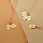 The Child Portrait Necklace features four gold and rose gold engraved oval pendants with angel and figure designs, making each piece a meaningful keepsake or thoughtful memorial necklace.