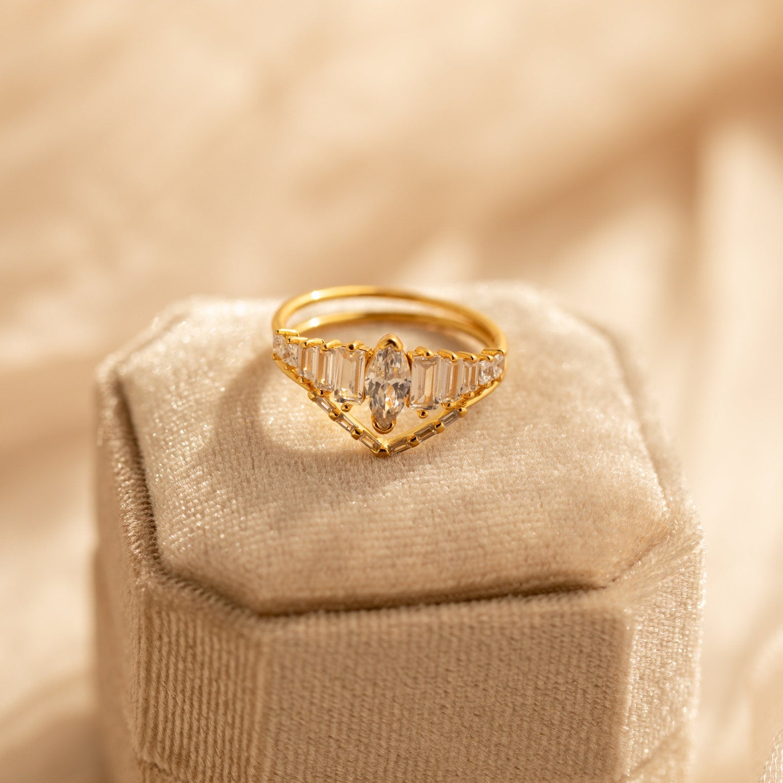Art Deco Ring Set featuring a marquise diamond and baguette accents, showcased on a cream velvet ring box.
