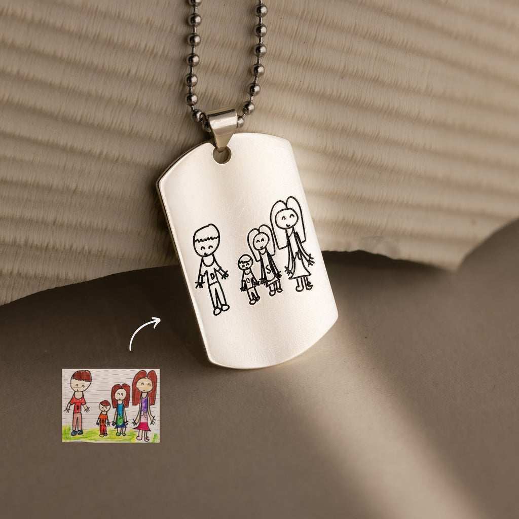 The Men's Dog Tag Necklace engraved with a child’s drawing of a family of four holding hands makes an unforgettable Father’s Day gift.