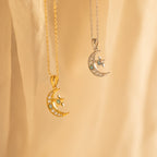 Two crescent moon and star necklaces—one gold, one silver—hang against a soft beige background, making a celestial duo perfect for layering with your favorite Opal Moon & Star Necklace.