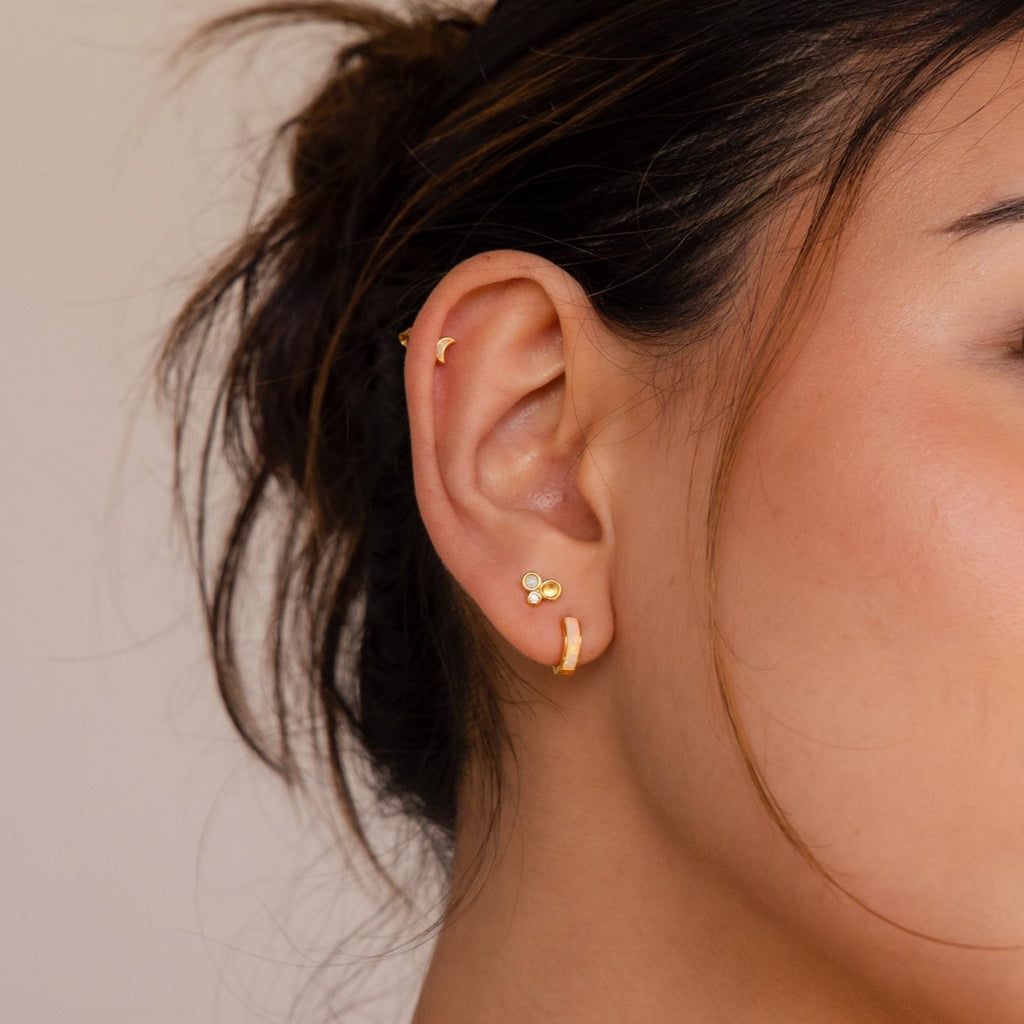Close-up of a woman's ear wearing the Opal Inlay Earrings Set—featuring a hoop, a stud, and a crescent on the upper ear—styled as an elegant jewelry gift for her.