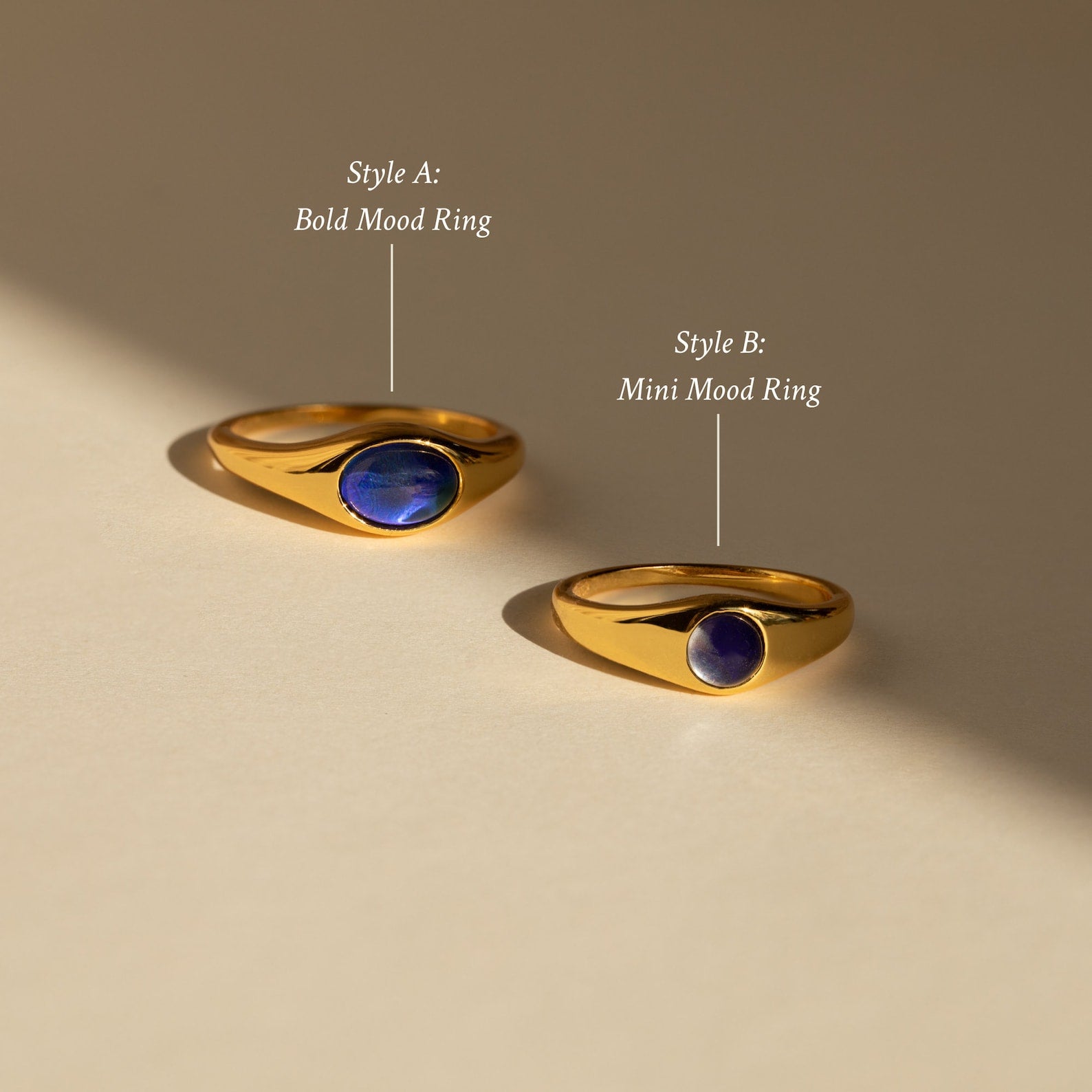 Signet Mood Rings Set: two gold color-changing rings—Style A (Bold) and Style B (Mini)—on a beige surface. Modern takes on classic Signet Mood Rings for a nostalgic jewelry vibe.