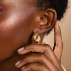 A close-up of a woman's ear wearing Bold Teardrop Studs, showcasing the elegance and style of these statement earrings.